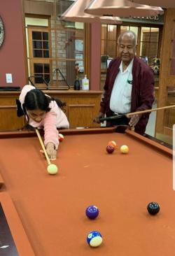 Azm and his daughter Omnia shoot a little pool together at Erin Meadows.