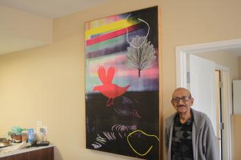 Mr. Mansaram stands beside one of his many great pieces of art. 