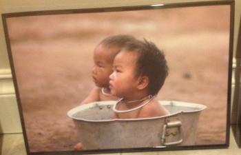 Small child sitting in a metal wash tub