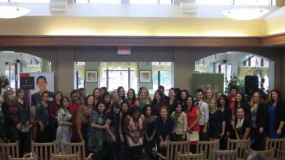 Large group of Conestoga Nursing students posing for a photo inside Riverside Glen