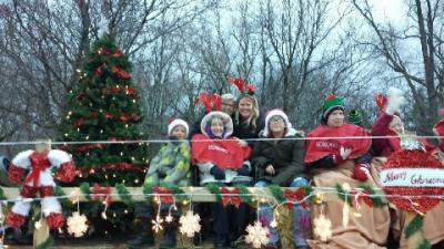 Residents sitting on a parade float outside