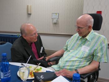 Ron Schlegel sitting on a chair speaking with David Kent from Erin Meadows